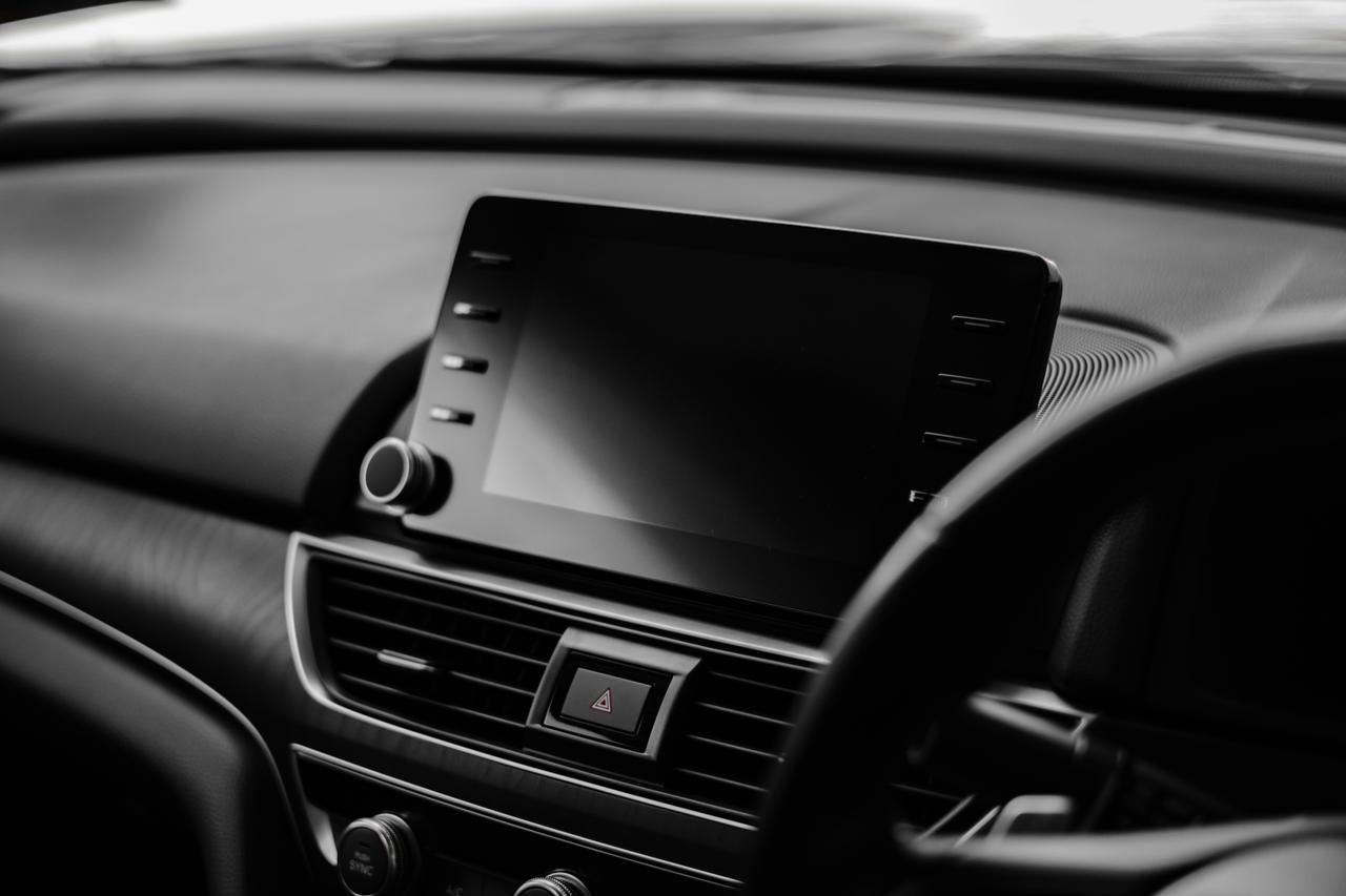 Dodirni ekran na centralnoj konzoli automobila sa ručicom i ventilacionim rešetkama